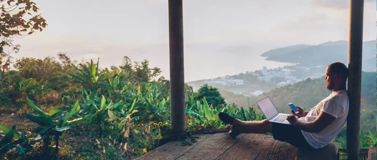 Man sitting on terrace, working with view