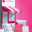 A small store design with shopping bags in front of it