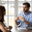 A man and woman talking in workplace